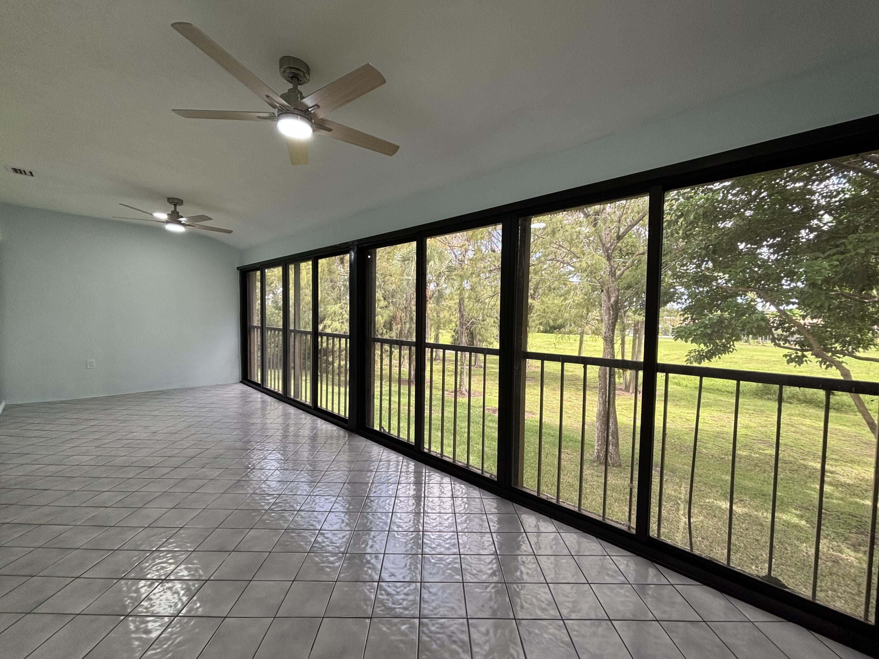 9266 Vista Del Lago, Unit 25H Boca Raton, FL 33428 - Photo 17 of 38 a view of an empty room with a large window