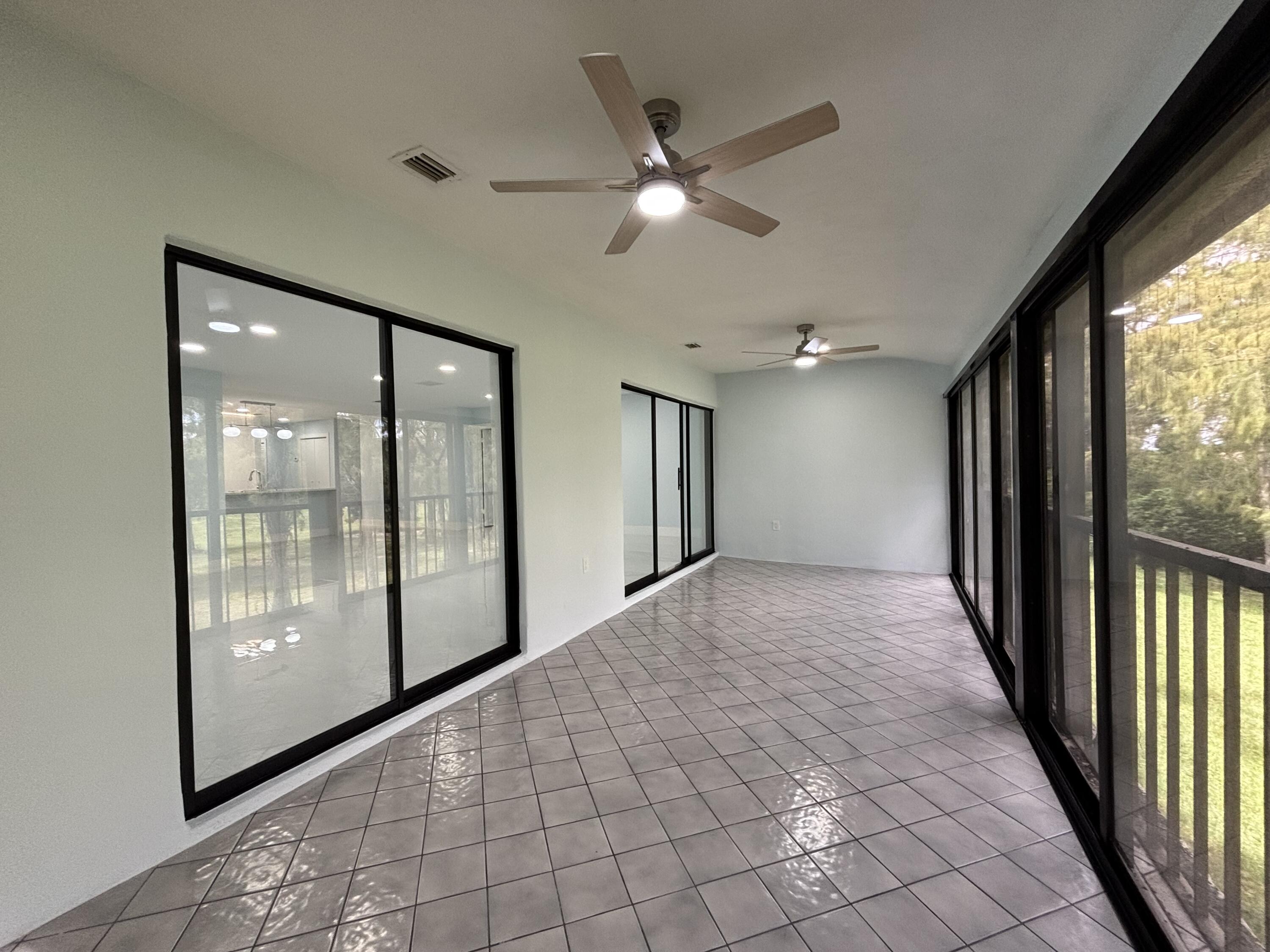 9266 Vista Del Lago, Unit 25H Boca Raton, FL 33428 - Photo 18 of 38 a view of a hallway with windows