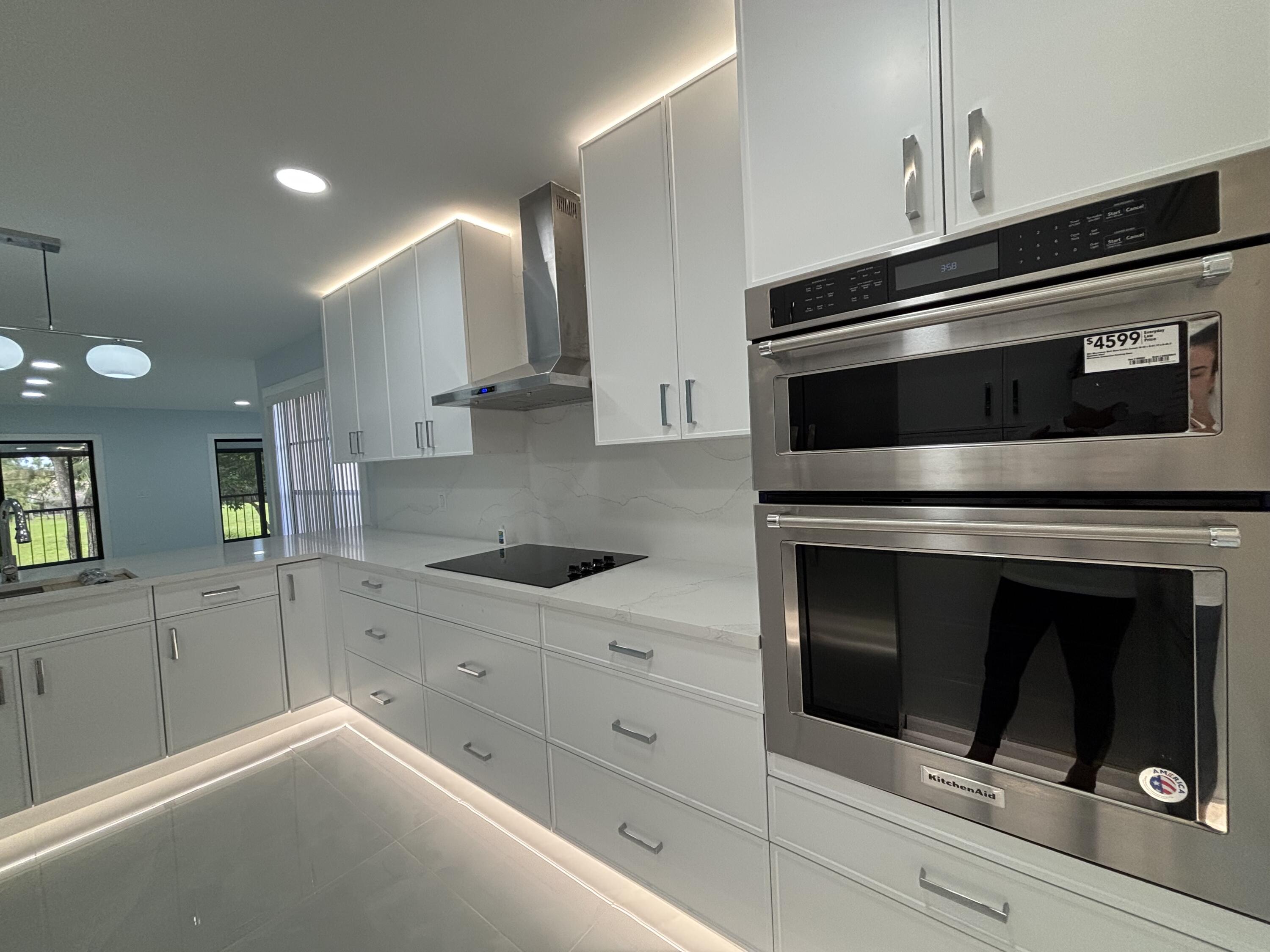 9266 Vista Del Lago, Unit 25H Boca Raton, FL 33428 - Photo 2 of 38 a kitchen with granite countertop white cabinets stainless steel appliances and sink