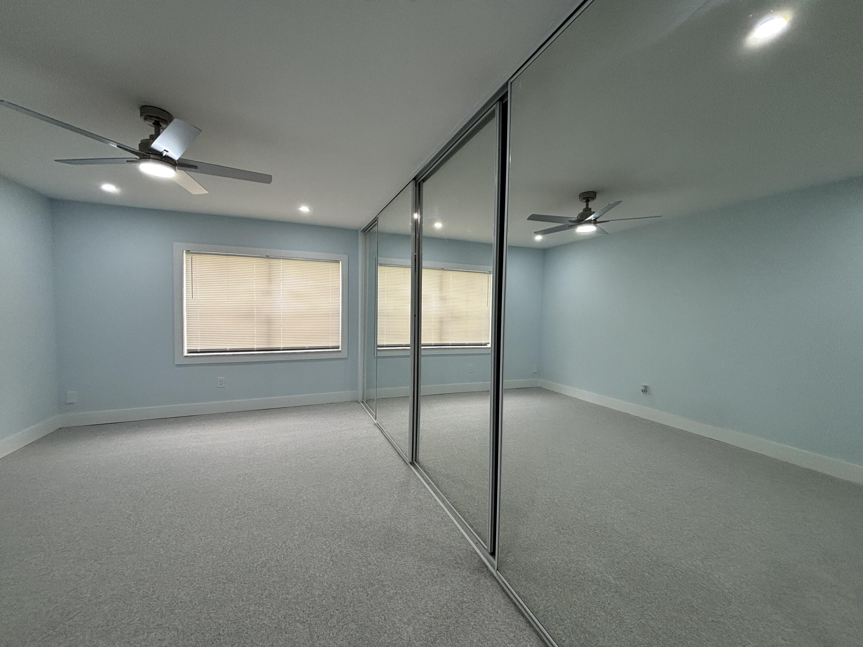 9266 Vista Del Lago, Unit 25H Boca Raton, FL 33428 - Photo 21 of 38 an empty room with windows and fan