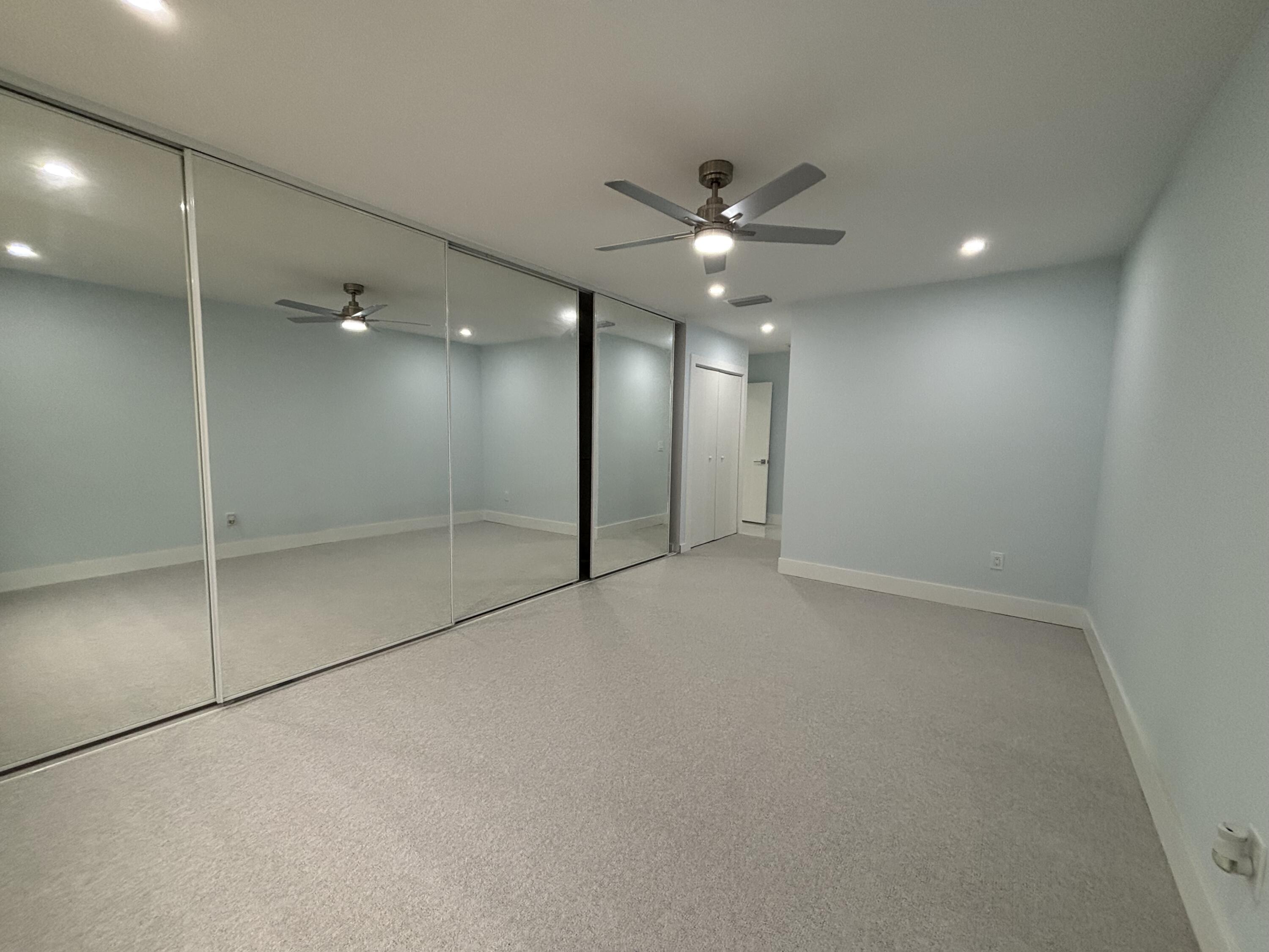 9266 Vista Del Lago, Unit 25H Boca Raton, FL 33428 - Photo 23 of 38 an empty room with a ceiling fan and bathroom