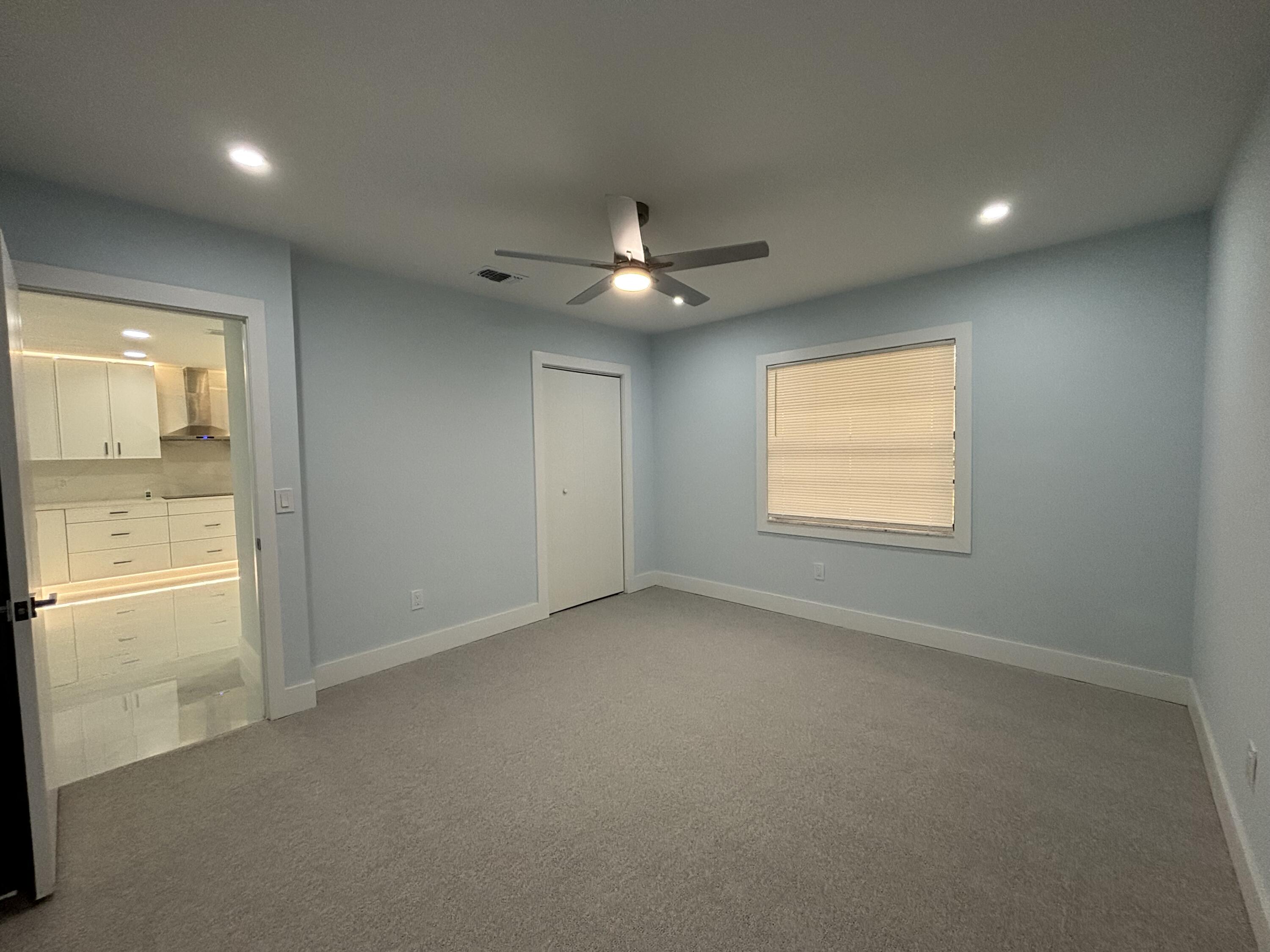 9266 Vista Del Lago, Unit 25H Boca Raton, FL 33428 - Photo 28 of 38 an empty room with windows and a ceiling fan