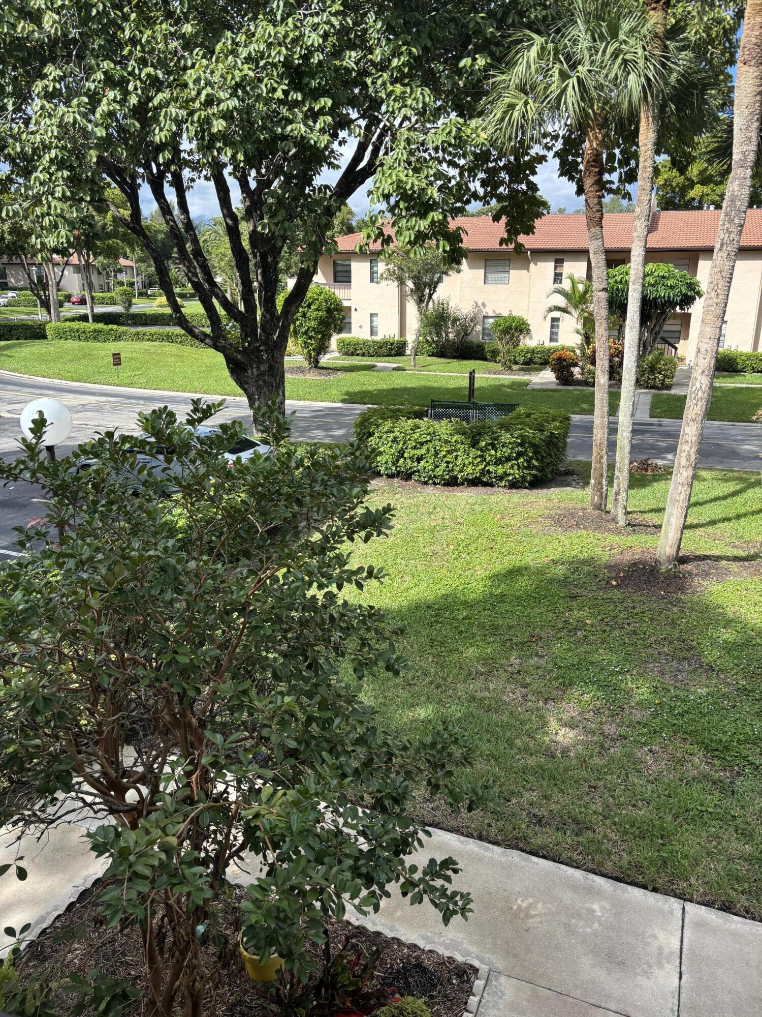 9266 Vista Del Lago, Unit 25H Boca Raton, FL 33428 - Photo 38 of 38 a view of a garden with a large trees