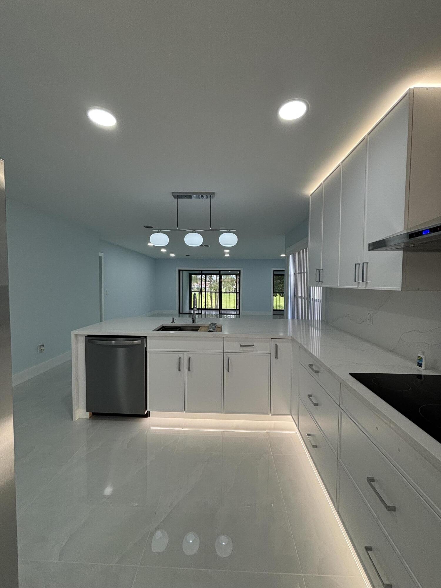 9266 Vista Del Lago, Unit 25H Boca Raton, FL 33428 - Photo 9 of 38 a kitchen with stainless steel appliances a sink stove and refrigerator