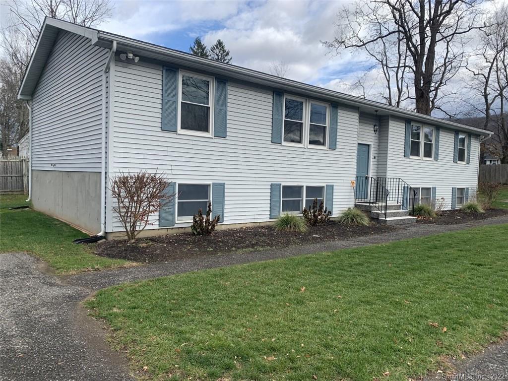 a view of a house with a yard