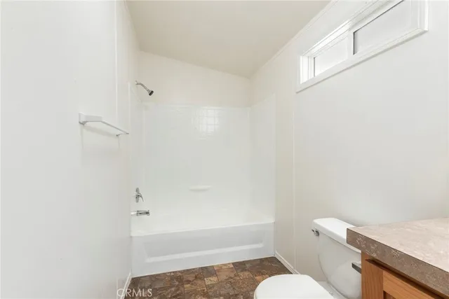 a bathroom with a toilet and a bathtub