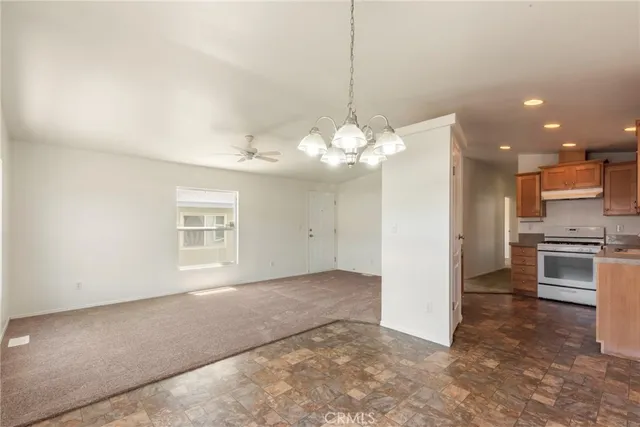 a view of a kitchen with a stove cabinets and a chandelier