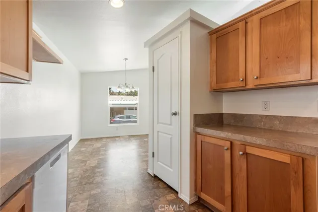 a kitchen with granite countertop cabinets stainless steel appliances and wooden cabinets
