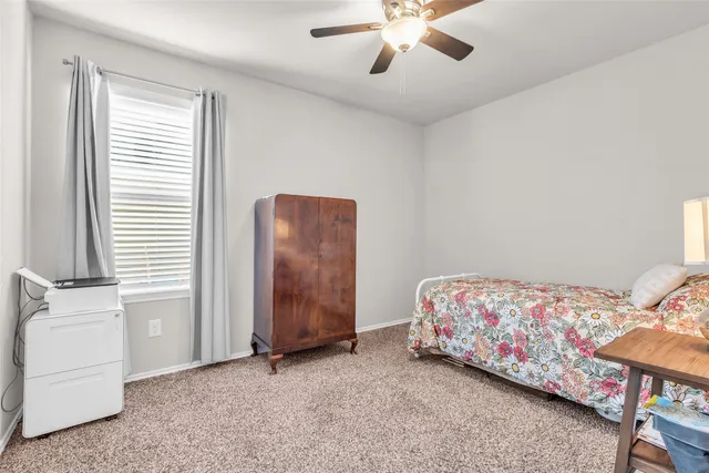a bathroom with a granite countertop sink toilet and a mirror