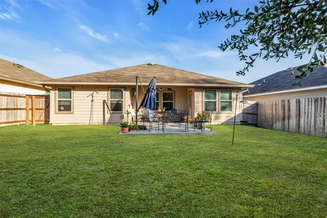 a view of a backyard with sitting area furniture and garden