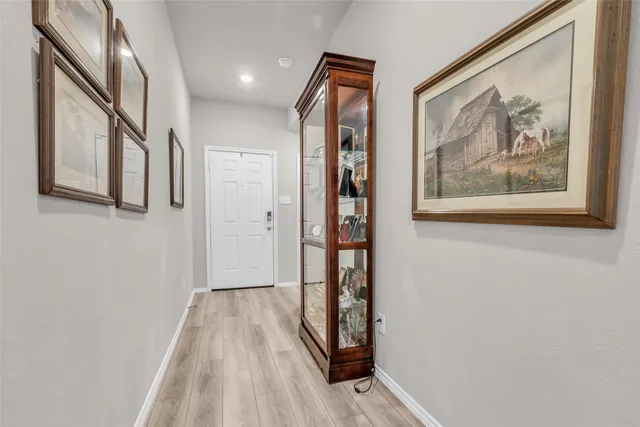 a living room with furniture and a flat screen tv with wooden floor