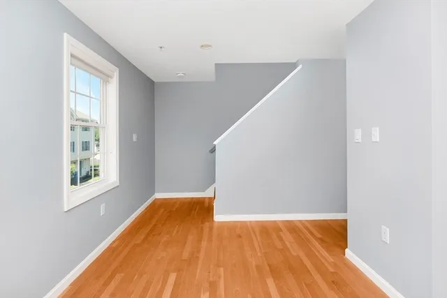 a view of a room with wooden floor and windows