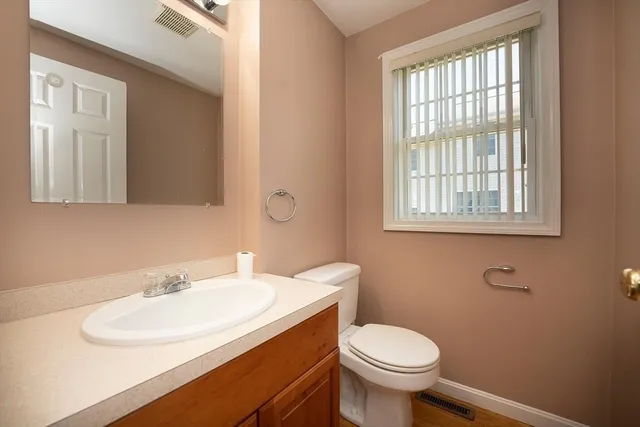 a white toilet sitting next to a bathroom sink