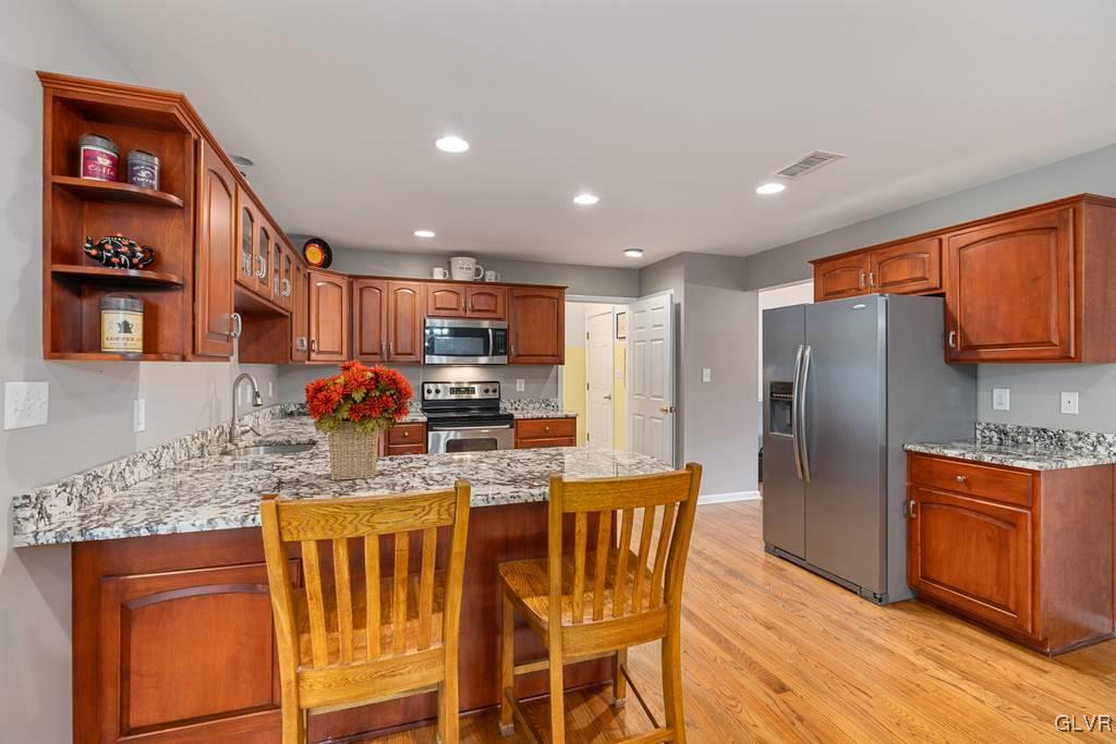 114 Peggy Lane Nazareth, PA 18064 - Photo 19 of 50 a kitchen with stainless steel appliances granite countertop a refrigerator a stove top oven and a sink