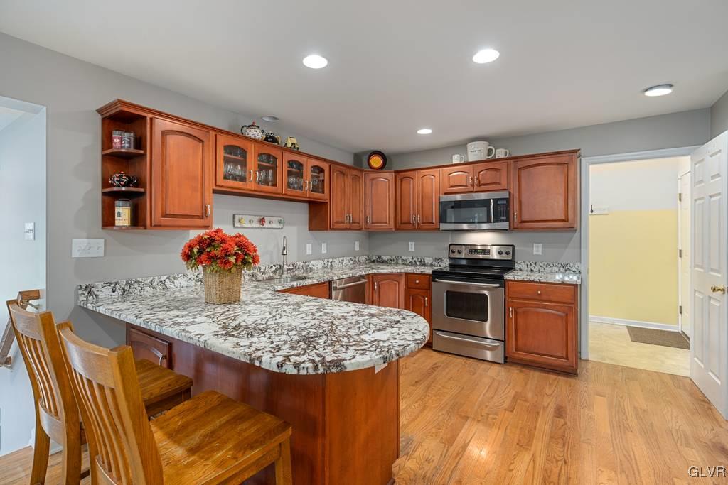 114 Peggy Lane Nazareth, PA 18064 - Photo 20 of 50 a kitchen with stainless steel appliances granite countertop a stove a sink a refrigerator and a microwave