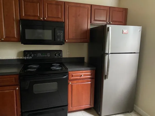 a kitchen with a stove microwave and refrigerator