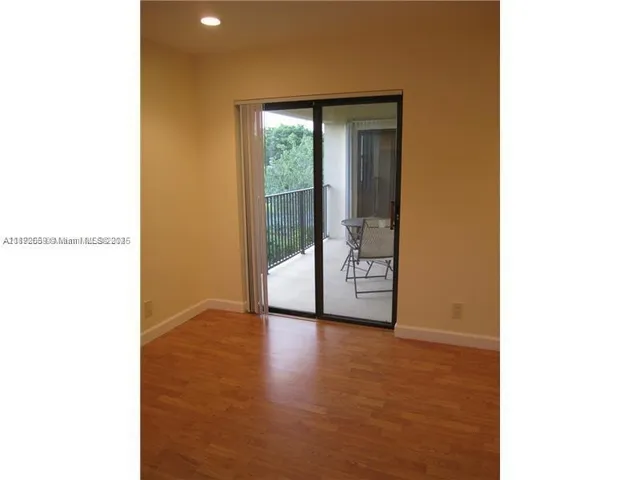 a view of an empty room with glass door