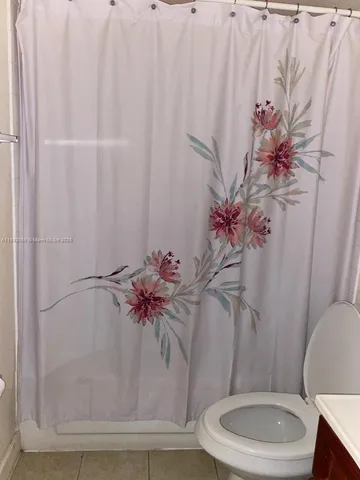 a bathroom with a toilet sink and shower