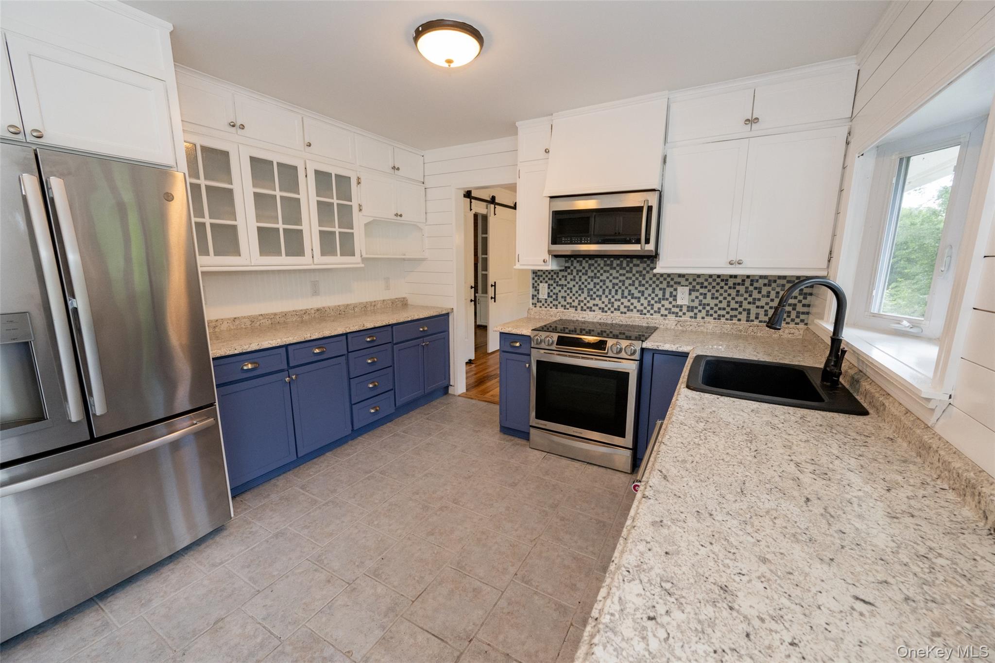 136 Foggintown Road Brewster, NY 10509 - Photo 10 of 50 a kitchen with stainless steel appliances granite countertop a stove a refrigerator and a microwave oven