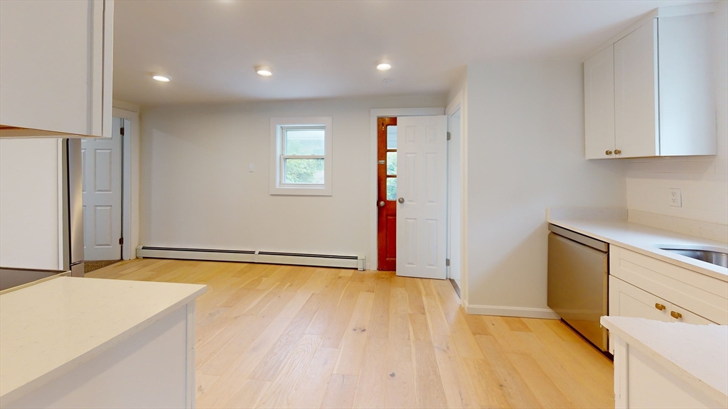 71 Water Street, Unit 1 Quincy, MA 02169 - Photo 2 of 10 a view of an empty room with window and wooden floor