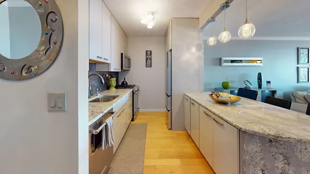 a kitchen with kitchen island a stove a sink and a refrigerator