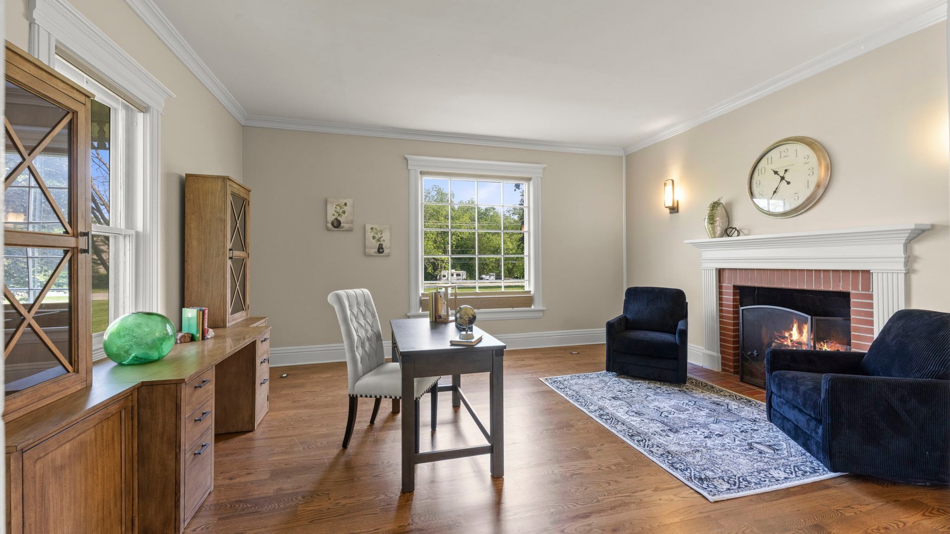 3614 Wolf Road Oswego, IL 60543 - Photo 12 of 56 a living room with furniture a rug a fireplace and a large window