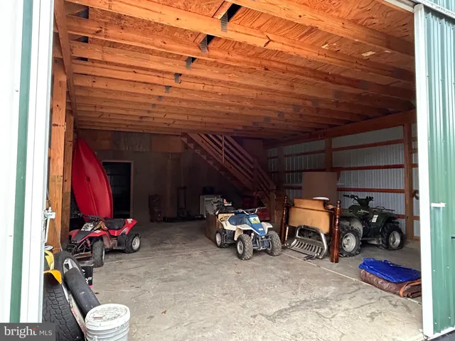 a front view of house with yard and trees in the background