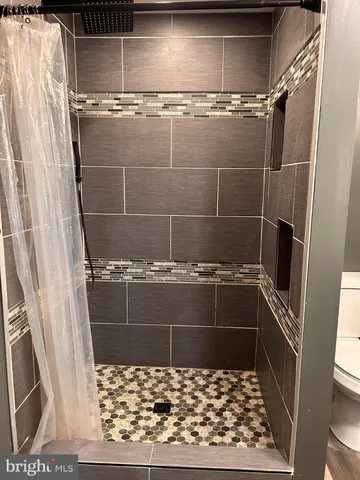 a bathroom with a glass door shower and a sink