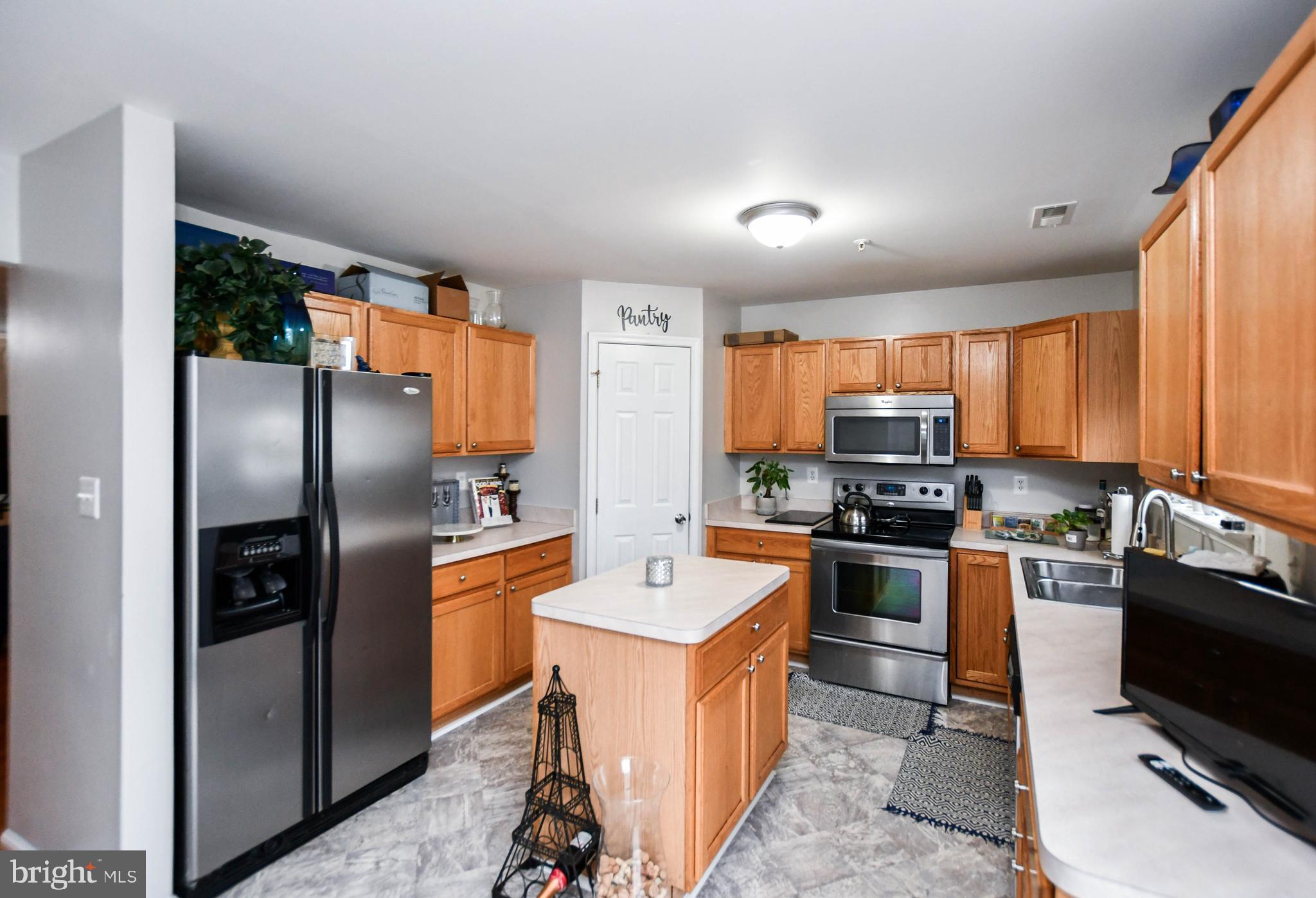 5534 Rockfish Way Clinton, MD 20735 - Photo 16 of 49 a kitchen with stainless steel appliances granite countertop a refrigerator a stove top oven a sink and dishwasher