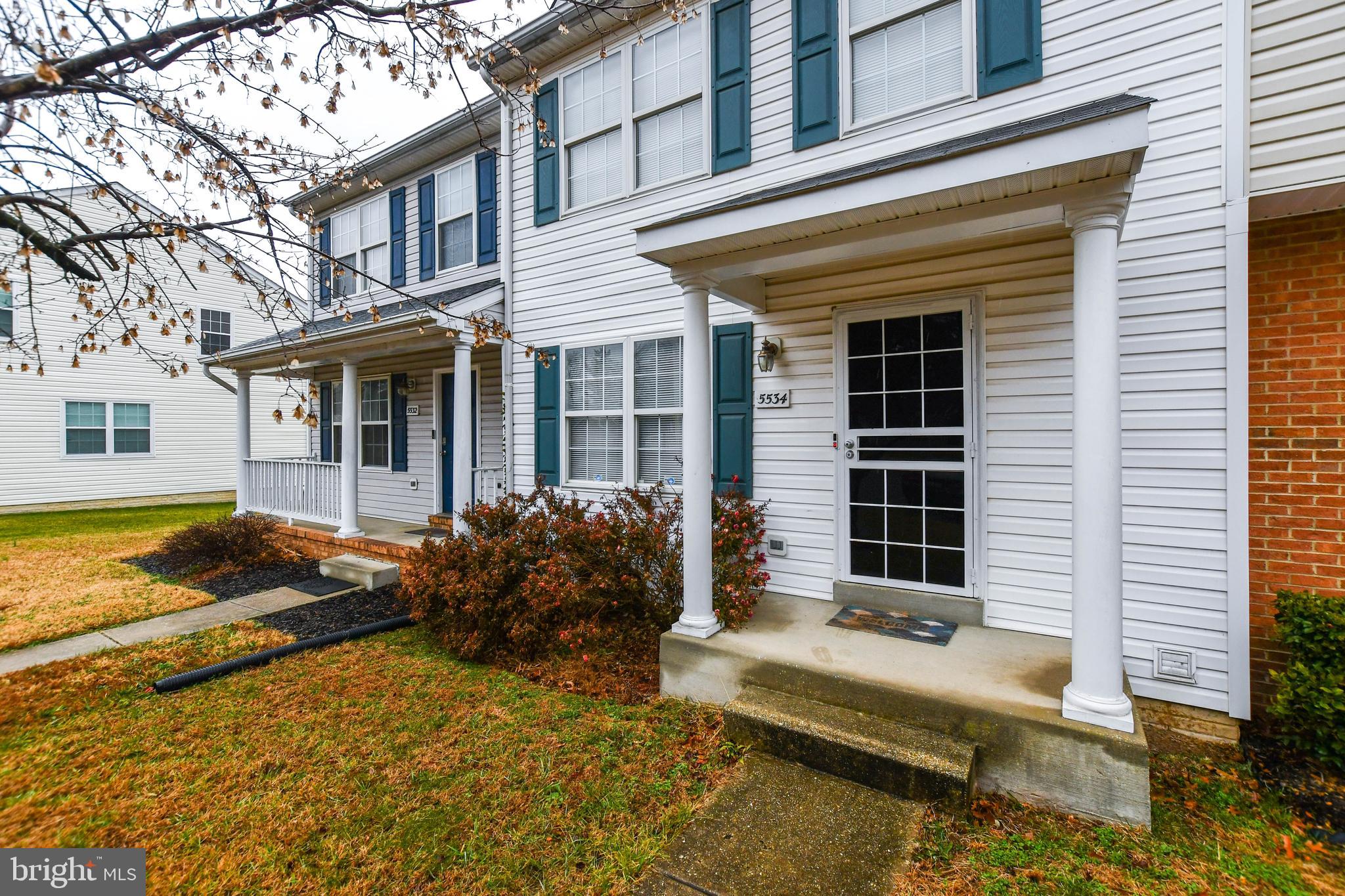 5534 Rockfish Way Clinton, MD 20735 - Photo 2 of 49 front view of a house with a large window and potted plants