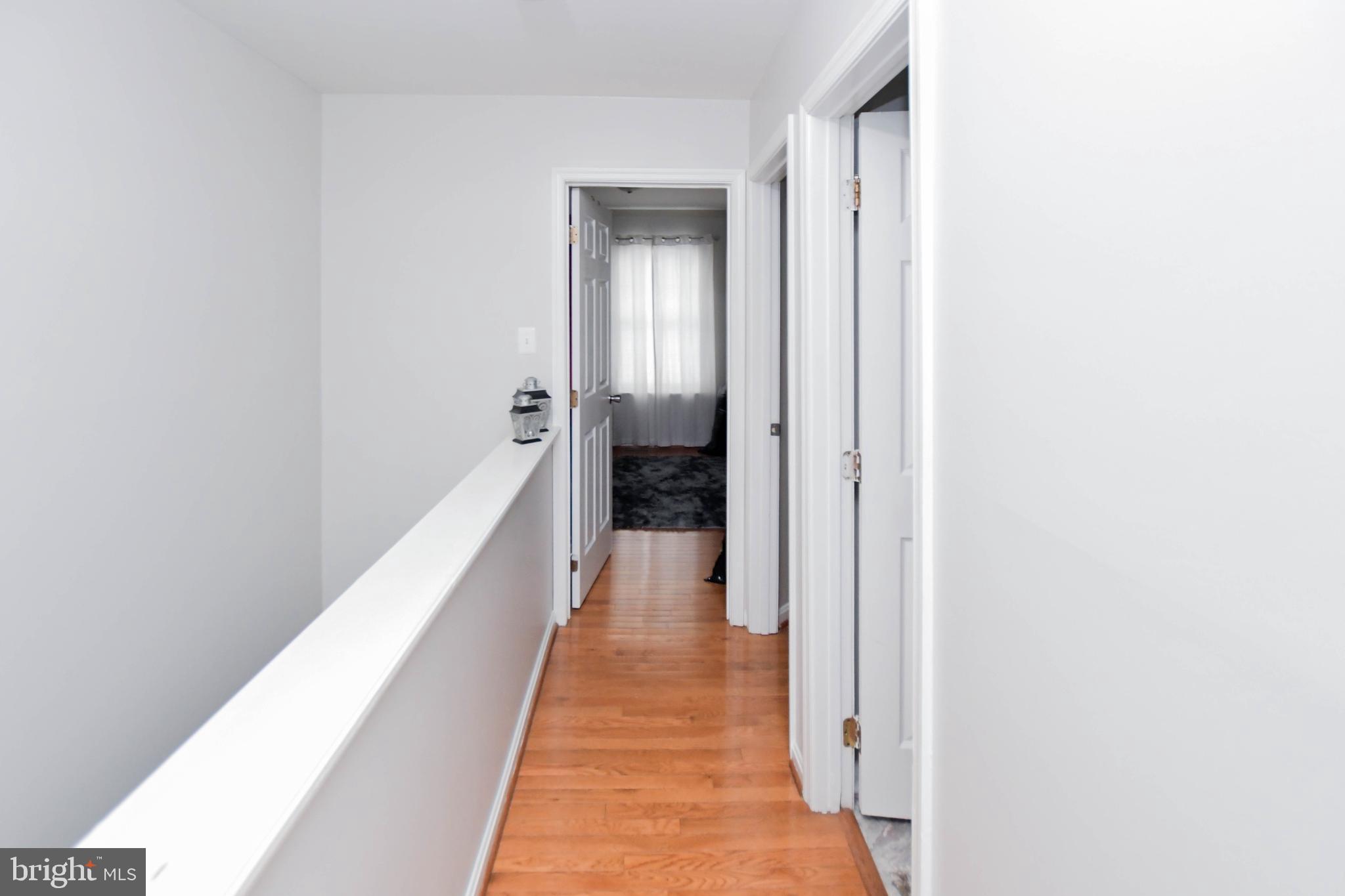 5534 Rockfish Way Clinton, MD 20735 - Photo 32 of 49 a view of a hallway with wooden floor