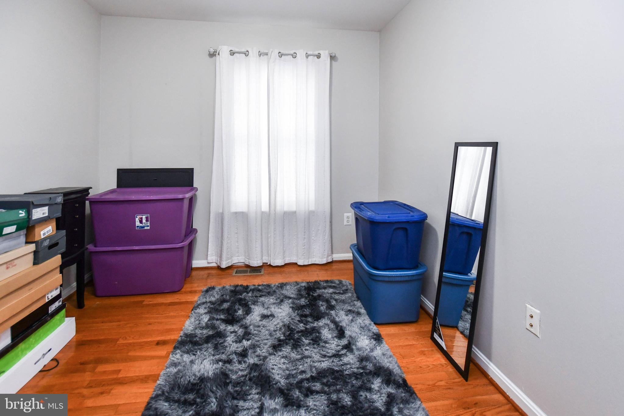 5534 Rockfish Way Clinton, MD 20735 - Photo 37 of 49 a bedroom with a bed and wooden floor