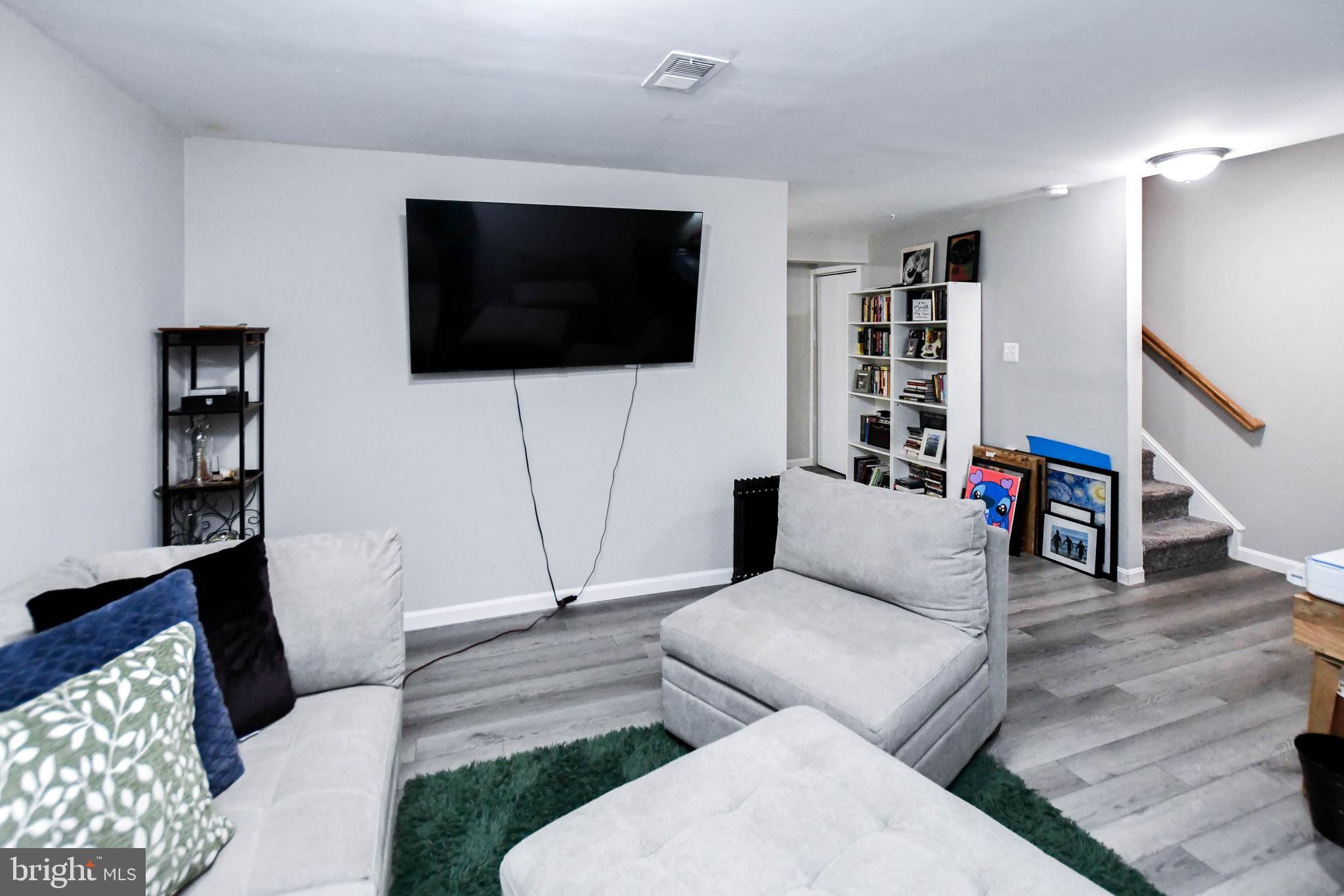 5534 Rockfish Way Clinton, MD 20735 - Photo 40 of 49 a living room with furniture and a flat screen tv