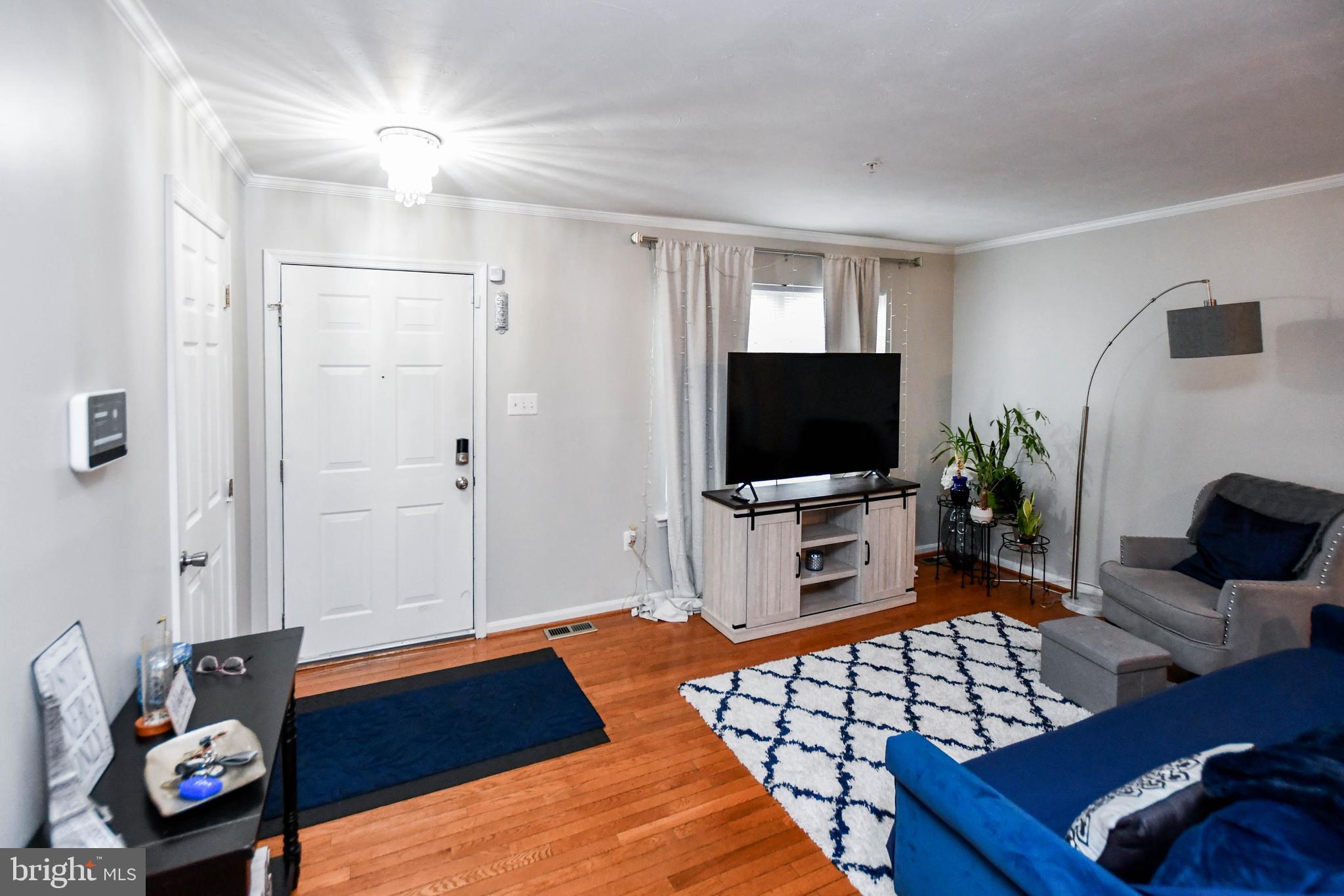 5534 Rockfish Way Clinton, MD 20735 - Photo 6 of 49 a living room with furniture and a flat screen tv