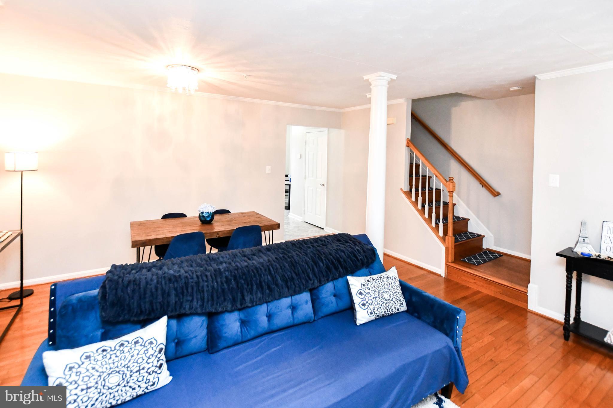 5534 Rockfish Way Clinton, MD 20735 - Photo 7 of 49 a living room with furniture and stairs