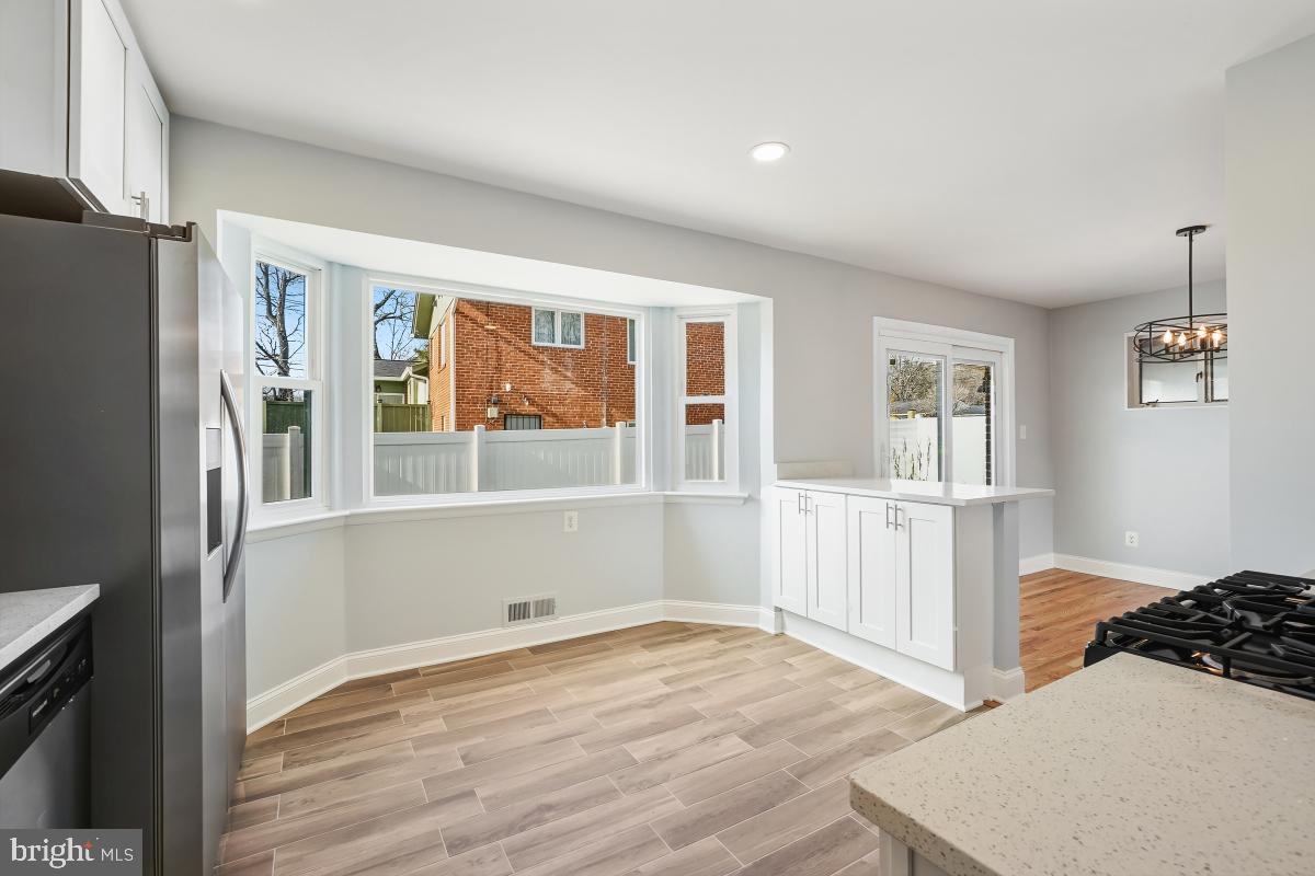 11514 Yates Street Silver Spring, MD 20902 - Photo 11 of 30 a view of empty room with wooden floor and fan