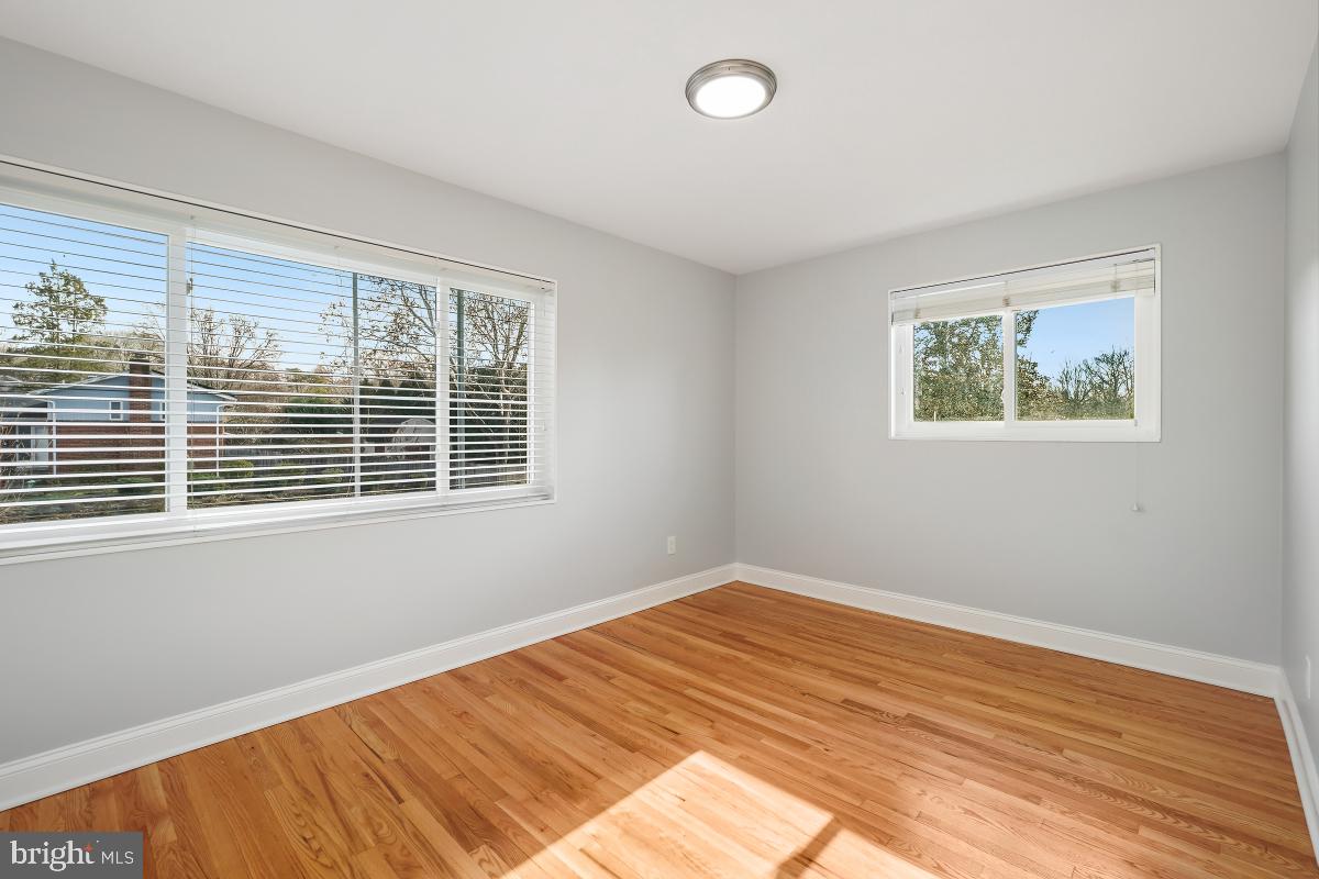 11514 Yates Street Silver Spring, MD 20902 - Photo 16 of 30 a view of a room with wooden floor and windows