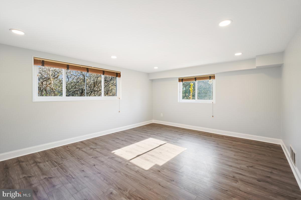 11514 Yates Street Silver Spring, MD 20902 - Photo 21 of 30 an empty room with wooden floor and windows