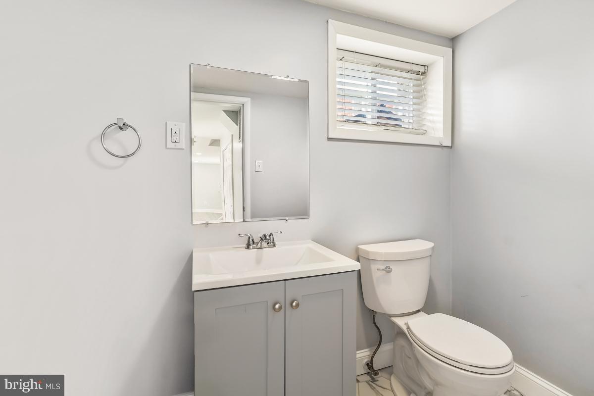 11514 Yates Street Silver Spring, MD 20902 - Photo 24 of 30 a white toilet sitting next to a bathroom sink