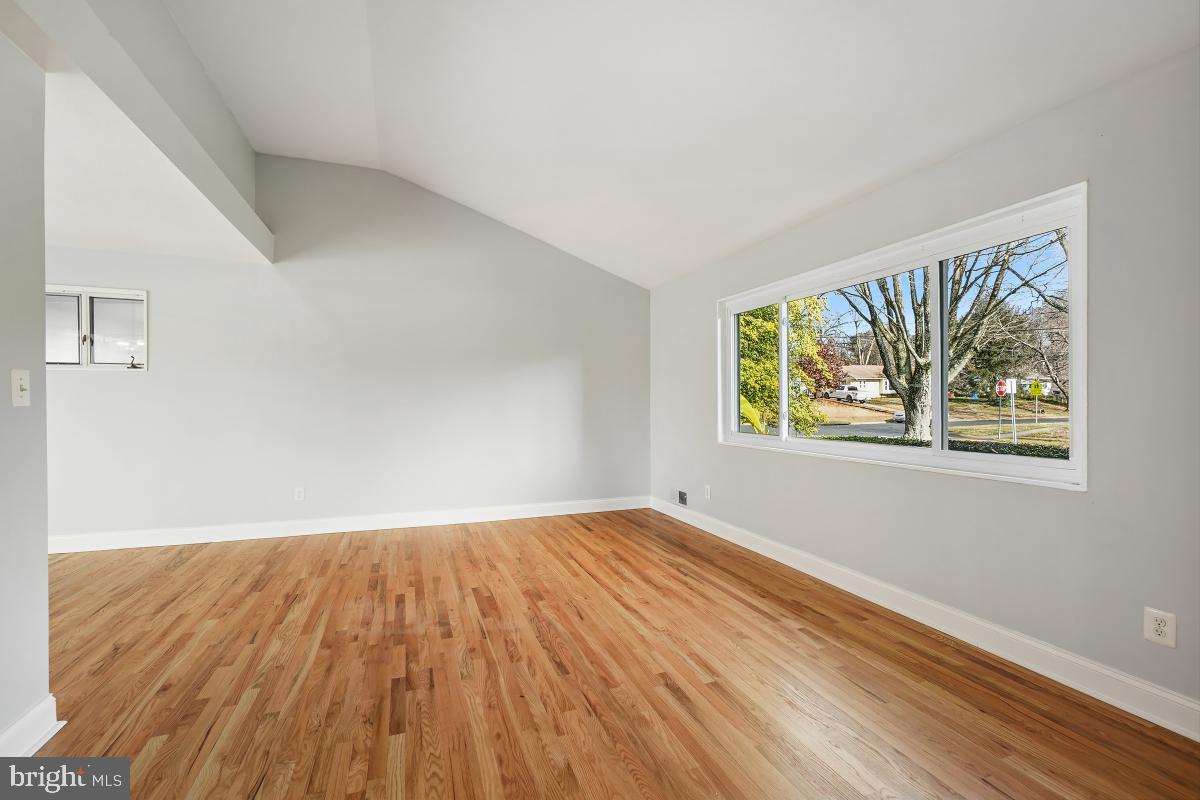 11514 Yates Street Silver Spring, MD 20902 - Photo 6 of 30 a view of an empty room with wooden floor and a window