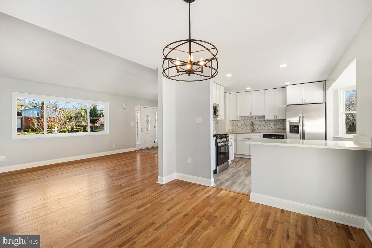 11514 Yates Street Silver Spring, MD 20902 - Photo 9 of 30 a view of a kitchen with a sink wooden floor and windows