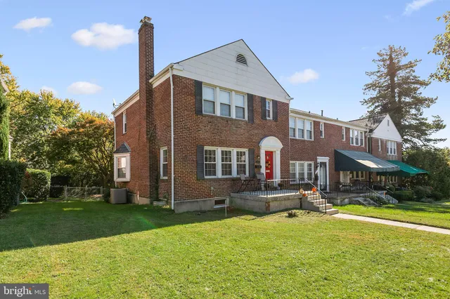a front view of building with yard and green space