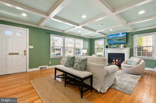 an empty room with wooden floor and fireplace