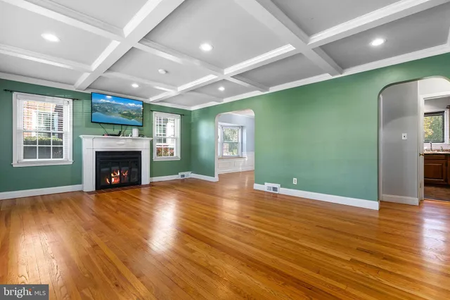 a living room with furniture and a hard wood floor