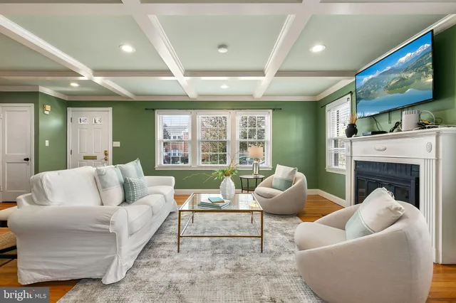 a living room with fireplace furniture and a wooden floor