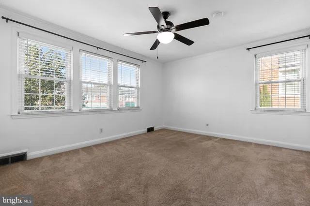 a spacious bedroom with a large bed and a window