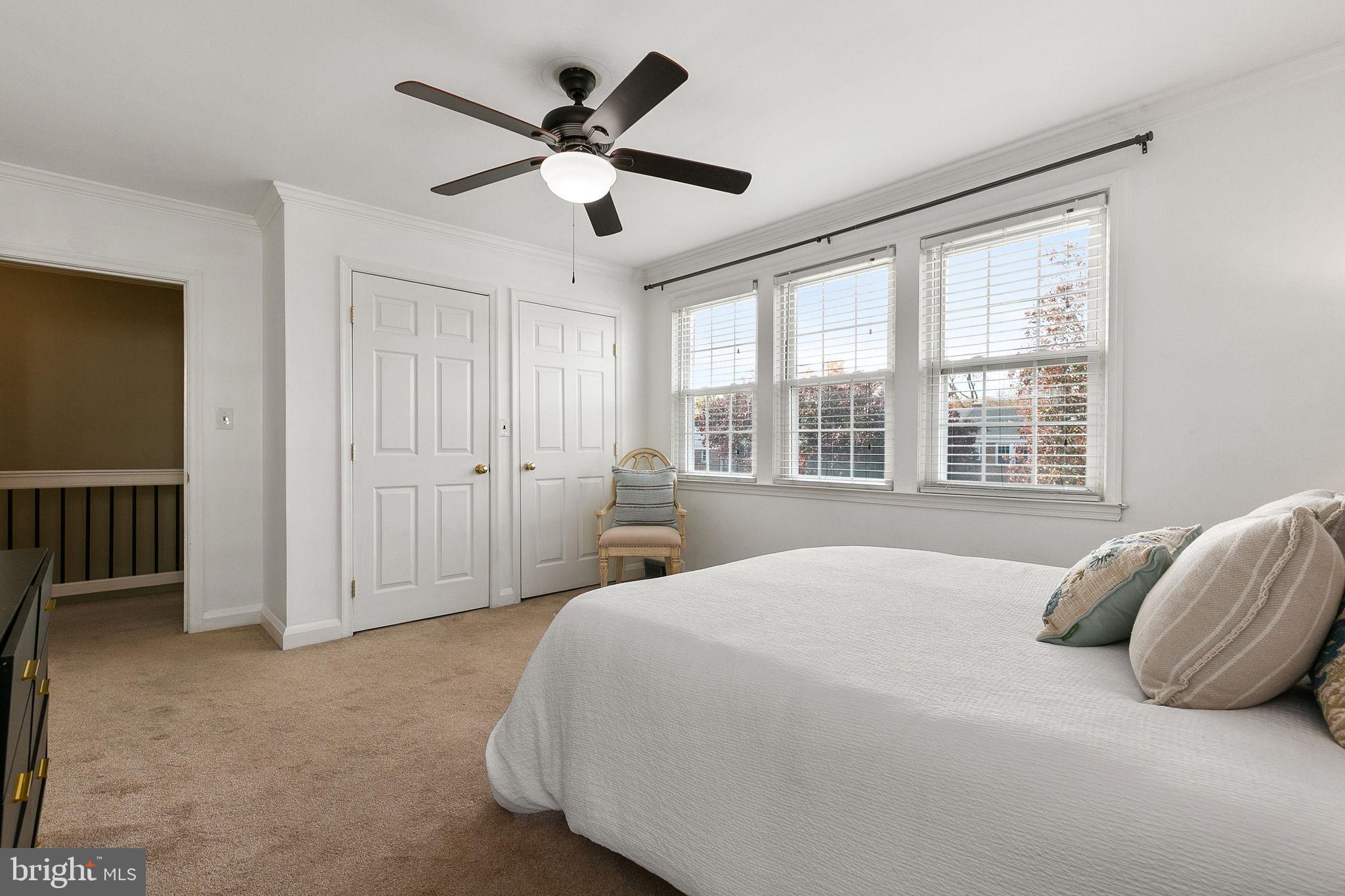 1860 Loch Shiel Road Towson, MD 21286 - Photo 33 of 58 a spacious bedroom with a large bed chandelier and a window