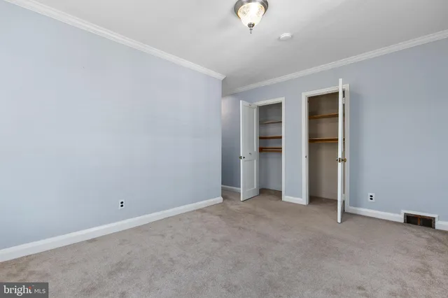 an empty room with a empty space and windows