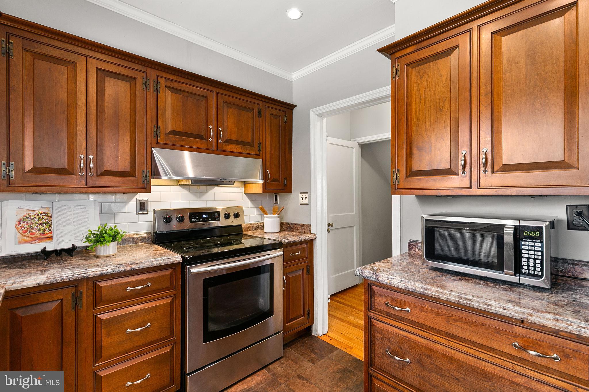 1860 Loch Shiel Road Towson, MD 21286 - Photo 10 of 58 a kitchen with granite countertop wooden cabinets stainless steel appliances and a counter space