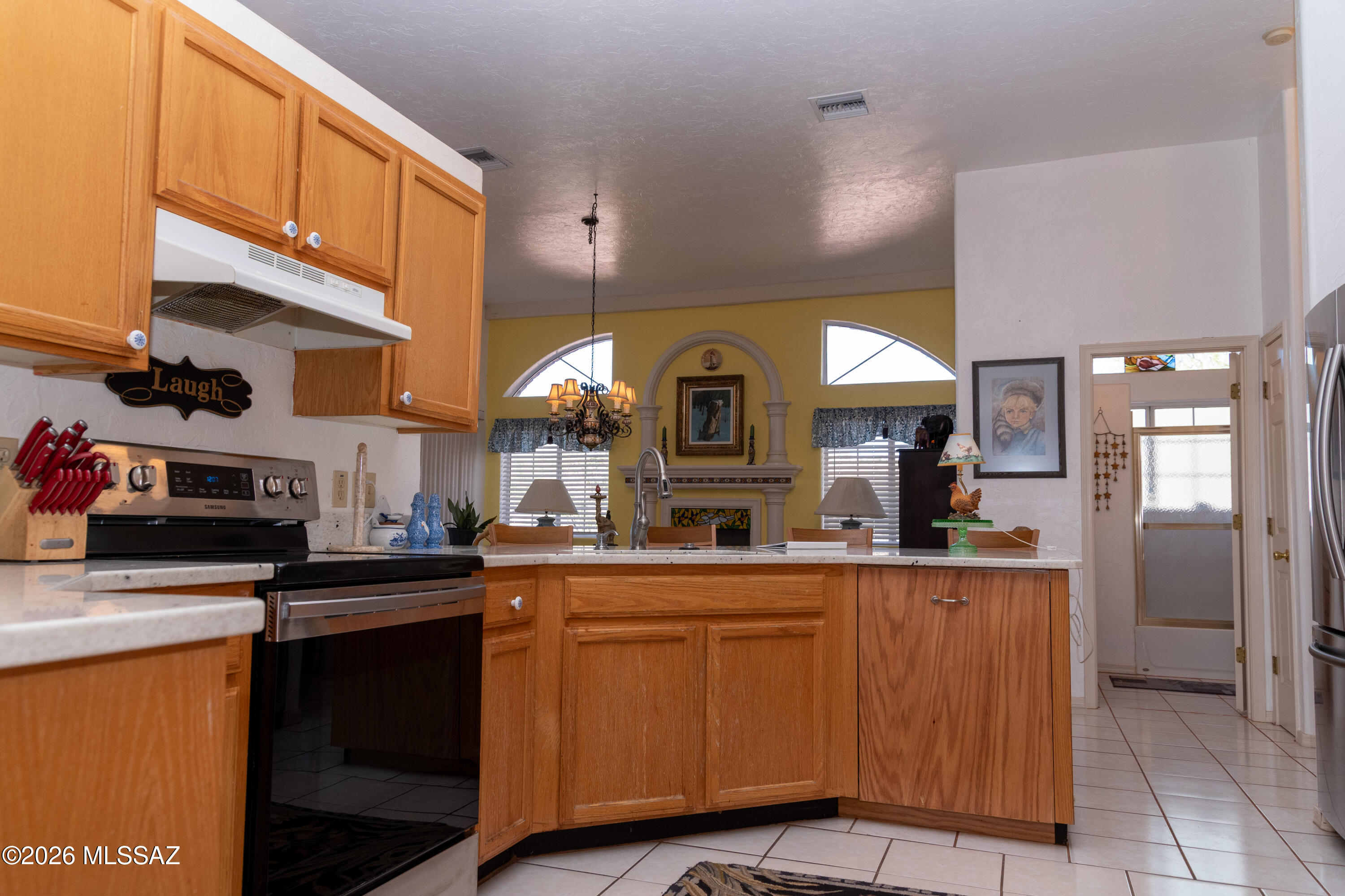 1242 Vista Court Rio Rico, AZ 85648 - Photo 5 of 16 a kitchen with stainless steel appliances granite countertop a sink a stove and cabinets